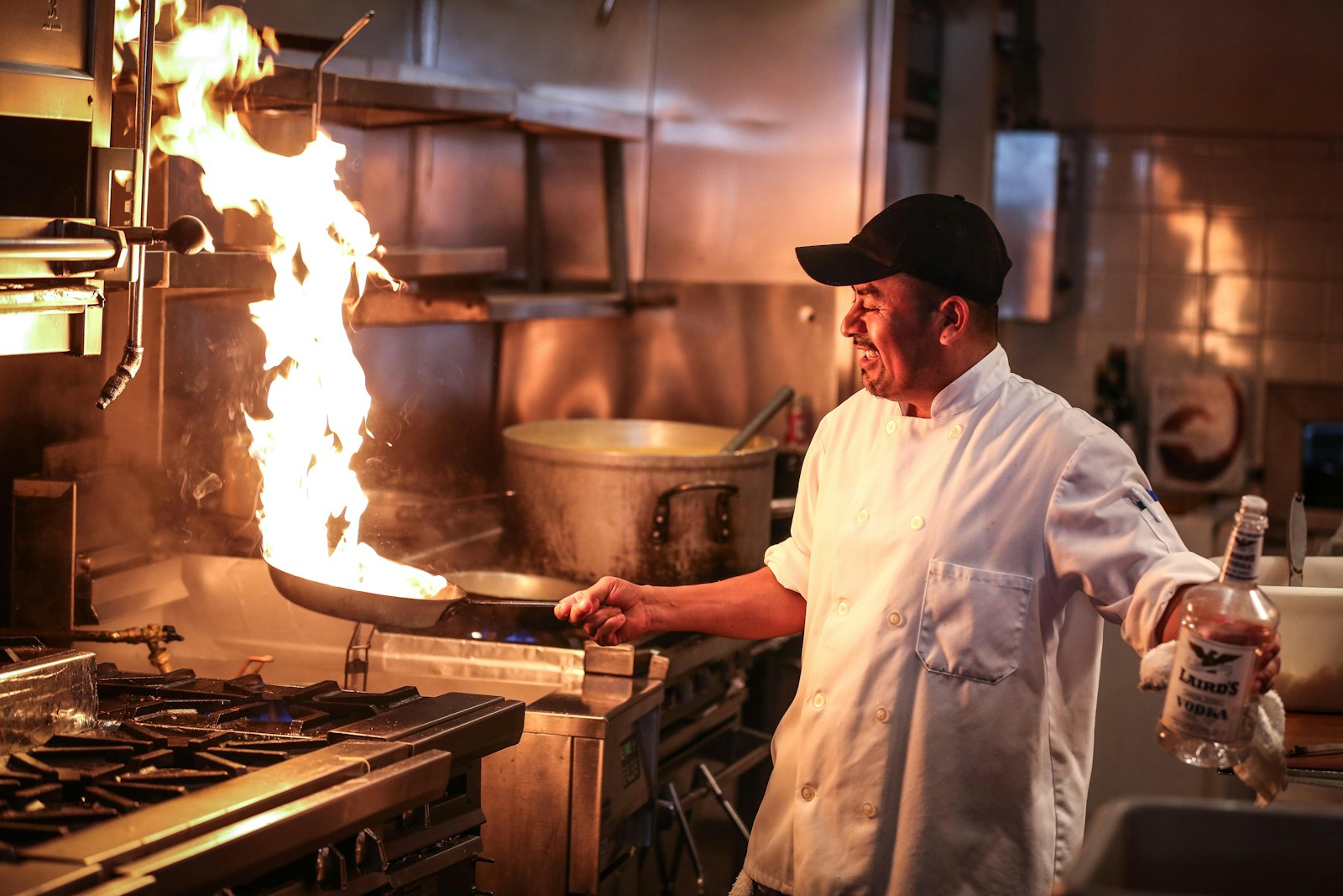 A chef cooking in a professional kitchen.