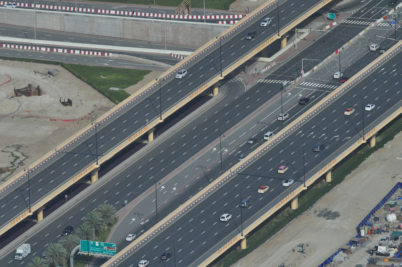 Aerial photograph of a wide concrete highway with multiple lanes.