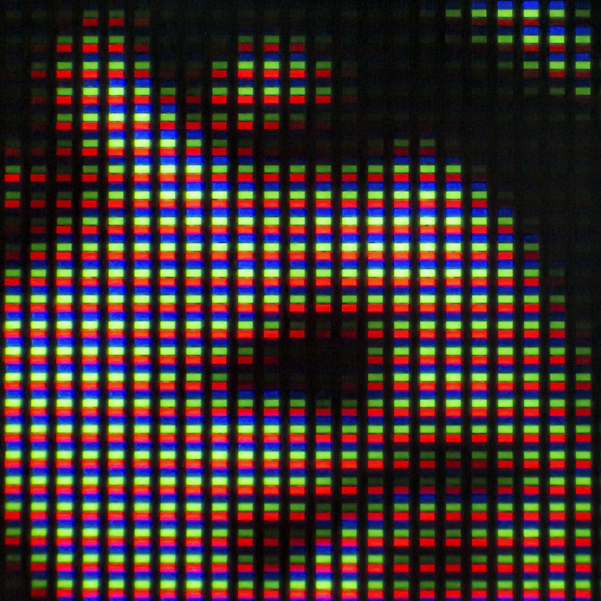 Extreme close-up of a digital display showing the red, green, and blue pixel grid.