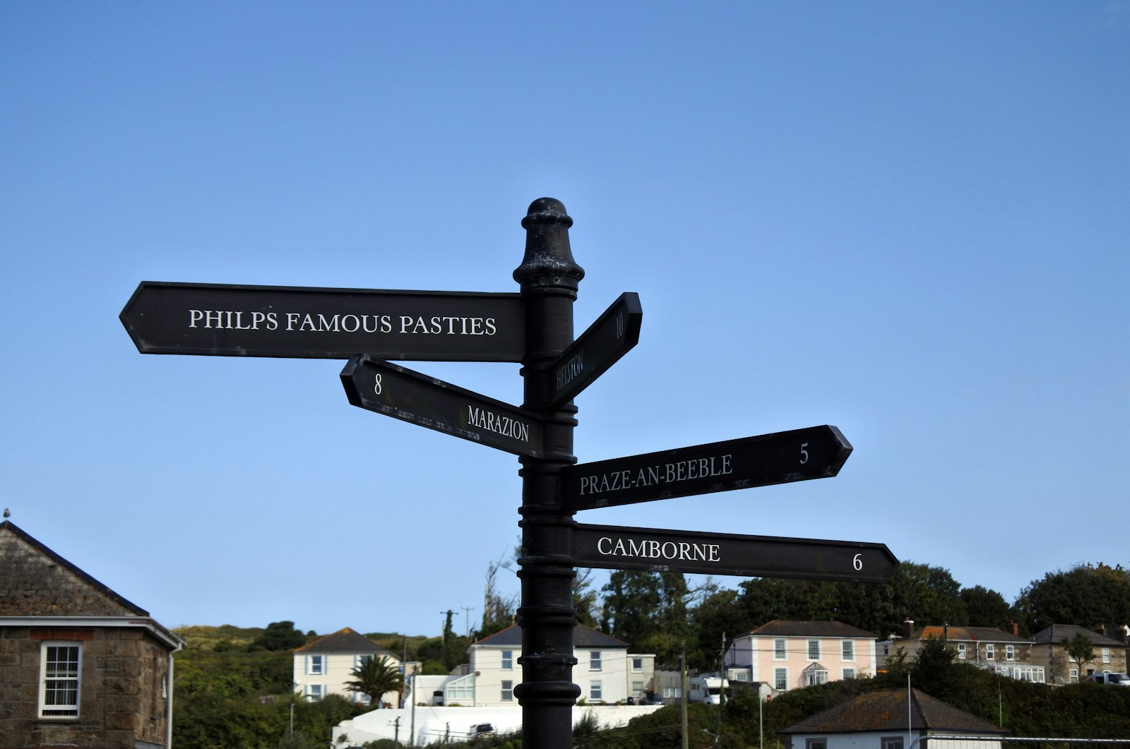 A pole with several street signs each pointing in a different direction.
