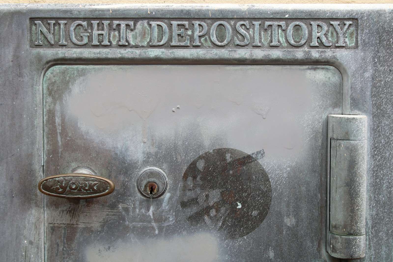 A close-up of a heavy metal door with a steel lock.