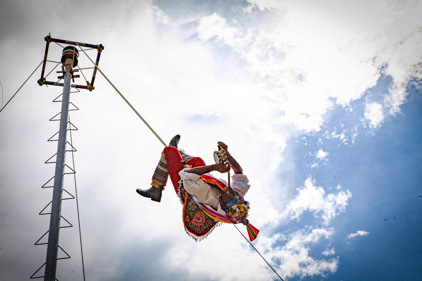A tightrope walker high above a city.