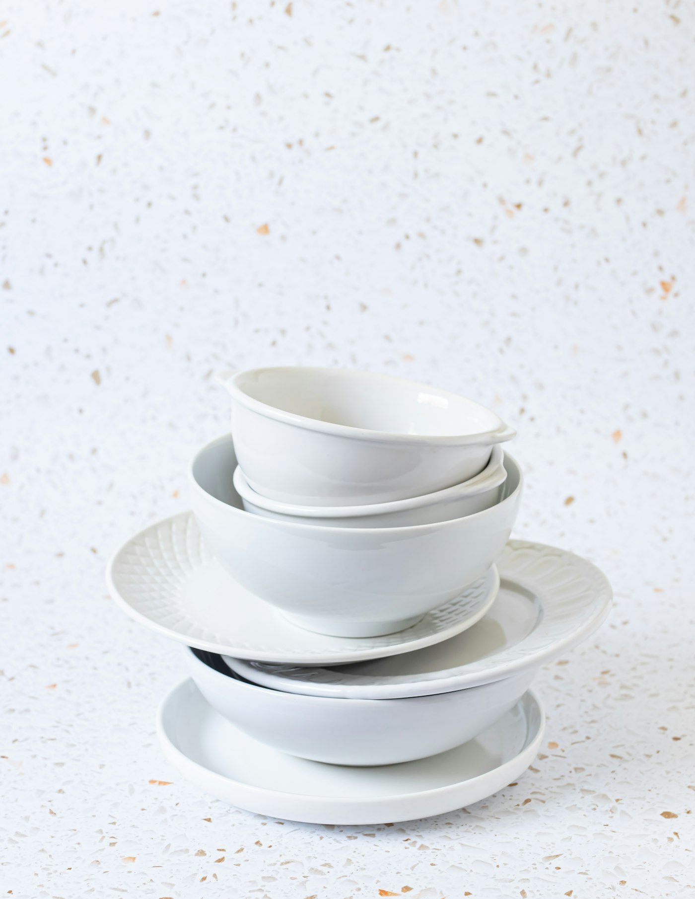 A tall stack of white plates.