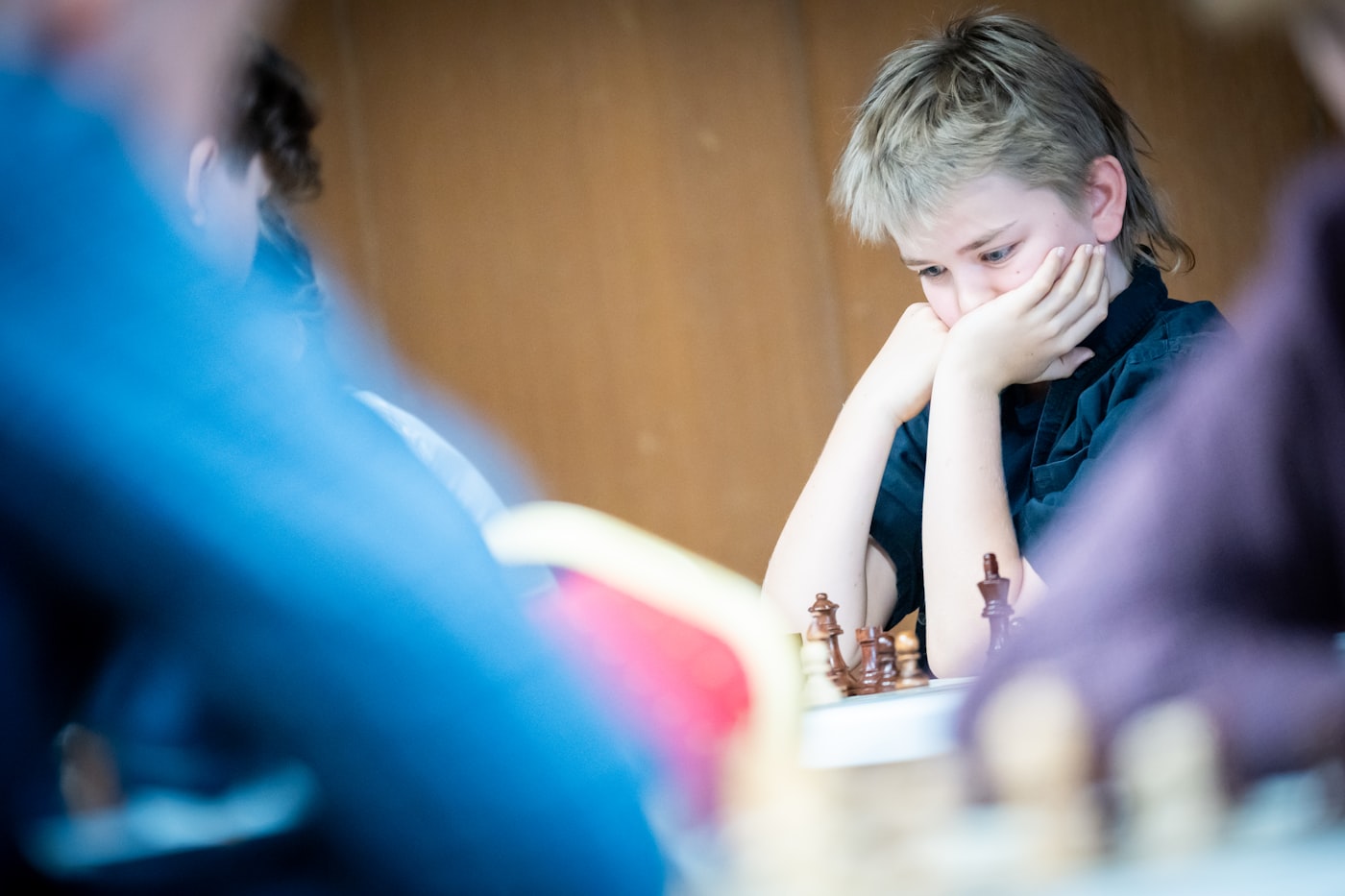 A young person concentrating during a chess game.